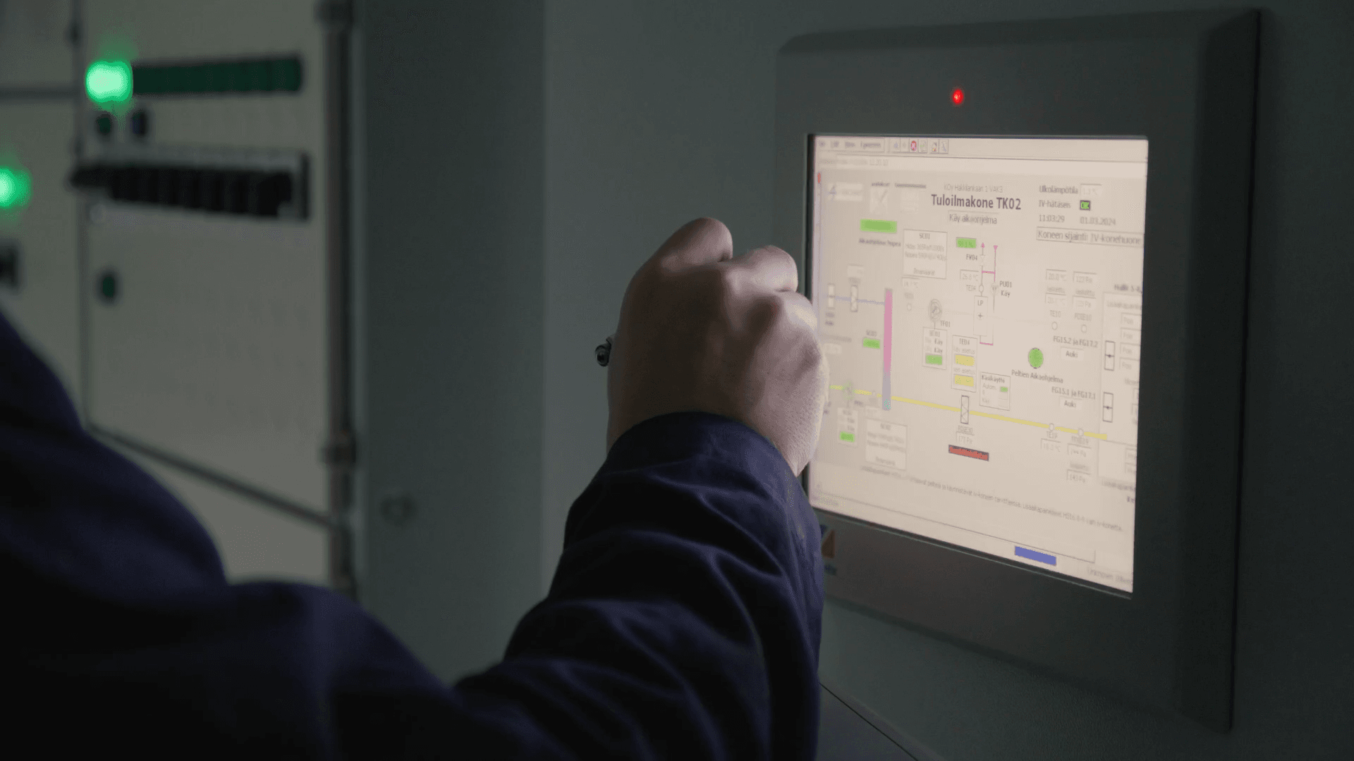 Person operating a touchscreen interface displaying a technical diagram with various labels and indicators.