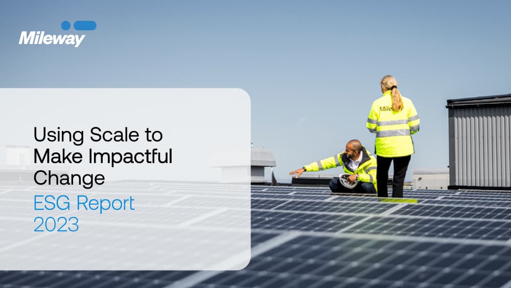 Two people in safety gear inspect solar panels on a rooftop. Text reads Using Scale to Make Impactful Change: ESG Report 2023.