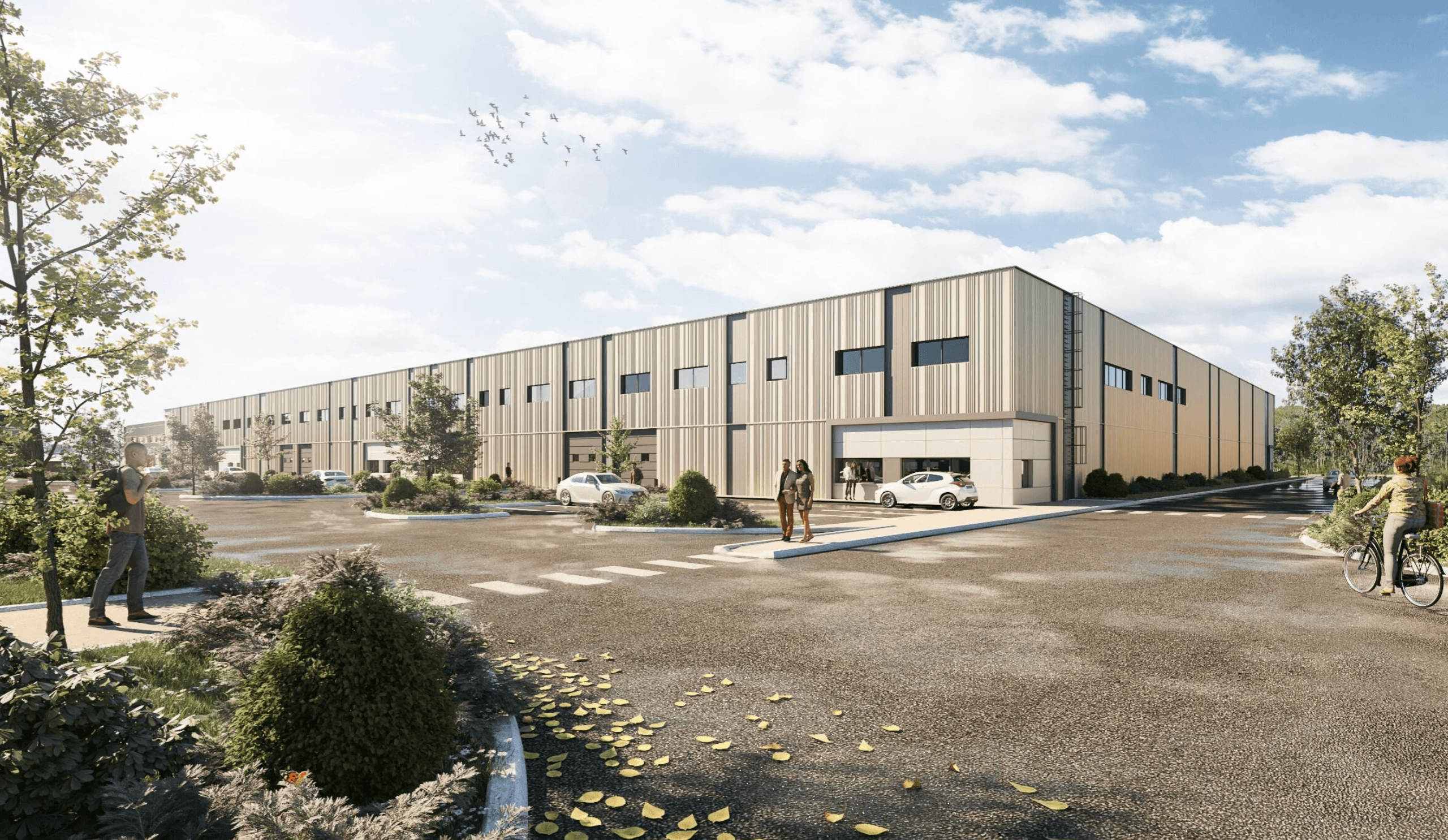 A large warehouse building with people walking and cycling in the parking area. There are parked cars, trees, and a clear sky with birds.