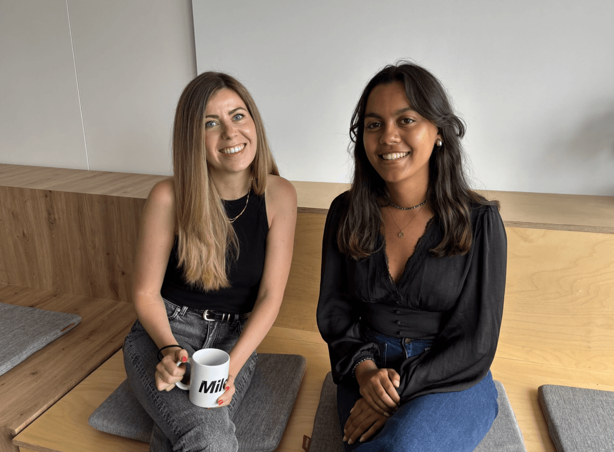 Two people sitting on a bench.