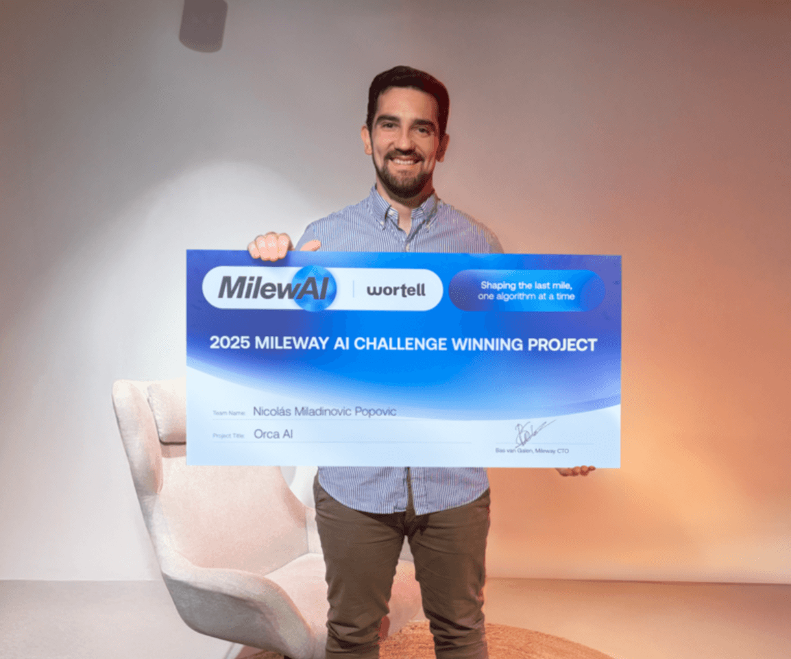 A man stands indoors holding a large sign that reads 2025 Mileway AI Challenge Winning Project and lists the team name as Orca AI and the winner as Nicolás Miladinovic Popovic.